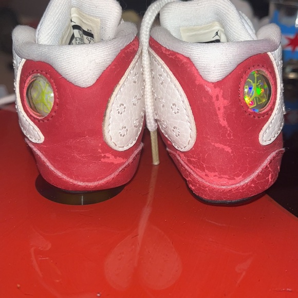 Red and white baby shoes Left side red color is peeling as shown in the pictures - Picture 2 of 7